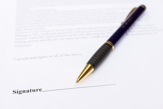 Pen for signature lying on contract paper