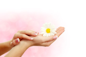 Young woman hands with elegance manicure on bright background
