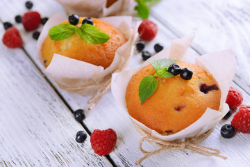 Tasty cupcakes with fruits on table close-up