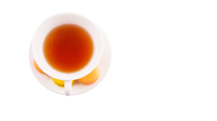 A cup of tea and yellow and orange colored macarons 