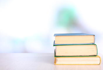 Books on wooden table on natural background