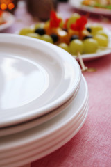 Buffet table with dishware waiting for guests