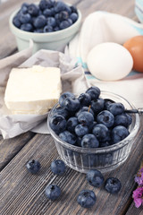 Fresh blueberries and milk products on wooden table