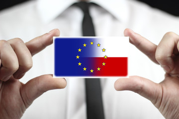 Businessman holding Poland and European Union Flag