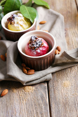 Baked apples in bowls on table close up