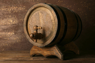 Barrel on wooden table on wooden wall background