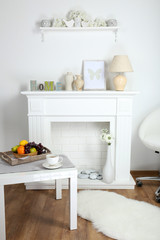 Fireplace with beautiful decorations in comfortable living room