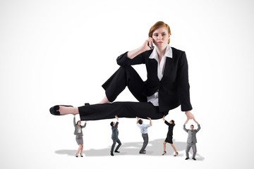Composite image of business team supporting boss