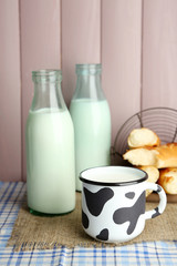 Obraz na płótnie Canvas Retro still life with tasty rustic milk, on table