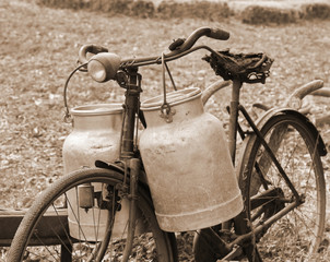 Rusty bike of a milkman of the last century with two bins