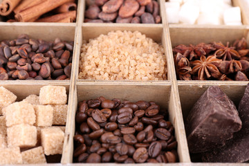 Wooden box with set of coffee and cocoa beans, sugar cubes,