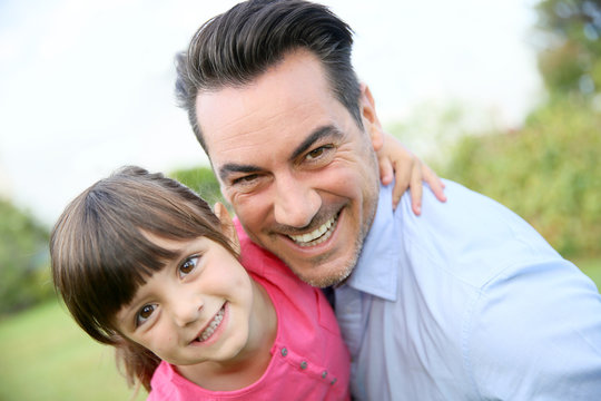 Portrait of little girl hugging her daddy