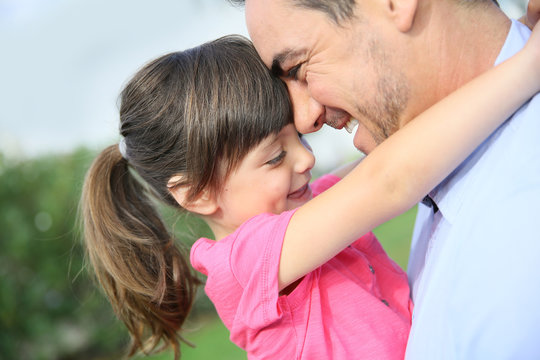 Portrait of little girl hugging her daddy