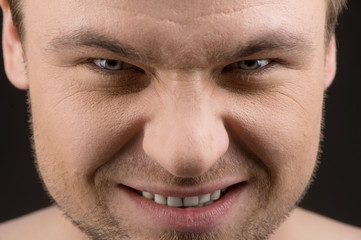 Angry caucasian man portrait on black background.