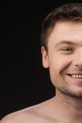 Fototapeta premium Facial close up of half attractive man face isolated