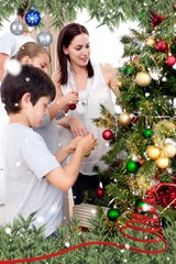 Happy children and parents decorating a christmas tree