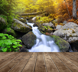 Obraz premium Autumnal forest with waterfall and wooden planks