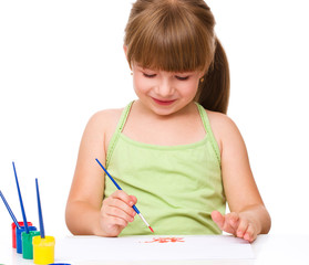 Cute thoughtful child play with paints