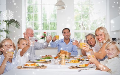 Composite image of happy family toasting at thanksgiving dinner