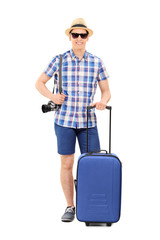 Young male tourist posing with his baggage