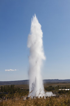 Geyser erruption with blue sky. Iceland
