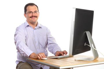 businessman sitting at desk in front of computer