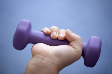 Child's hand exercise with dumbbell
