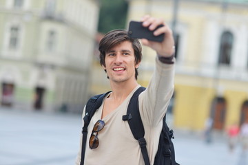 Student / tourist taking funny self portrait in the europe