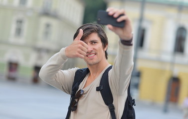 Fototapeta premium Student / tourist taking funny self portrait in the europe
