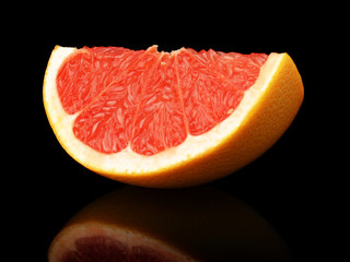 Studio shot quarter grapefruit isolated black