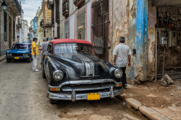 Street scene with vintage car in Havana, Cuba.