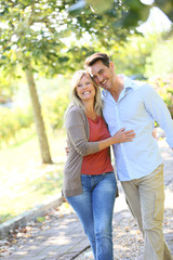 Couple walking hand in hand in park