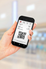 hand holding mobile phone with mobile boarding pass