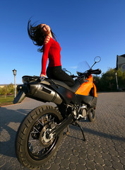 Fototapeta na wymiar Beautiful young brunette on a motorcycle.