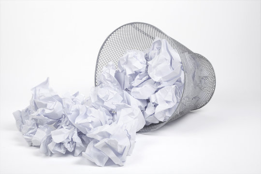 Silver trash bin and papers