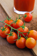 Tomato juice and  cherry tomatoes on the vine