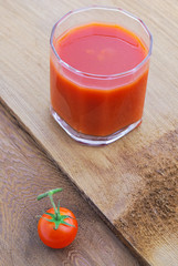 Tomato juice and  cherry tomatoes on the vine