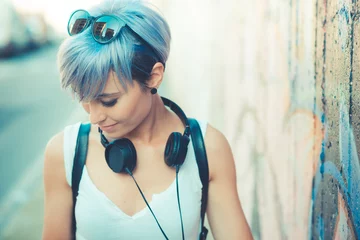 Foto op Aluminium young beautiful short blue hair hipster woman with headphones mu © Eugenio Marongiu