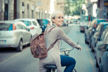 beautiful young blonde short hair hipster woman with bike