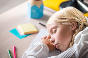 Naklejka premium Sleeping school girl in classroom