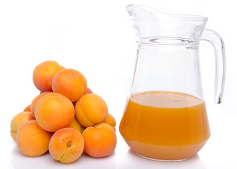 Heap of apricots and a jug of apricot juice
