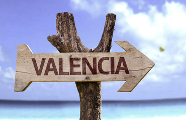 Valencia wooden sign with a beach on background