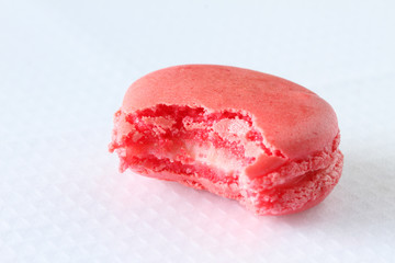 bitten french macaroons on white background
