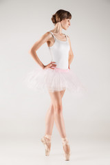 Naklejka premium Ballet dancer in white tutu posing