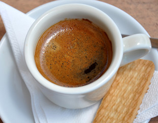 Fresh coffee in a cup and biscuits