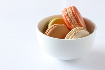 colourful french macaroons on white background