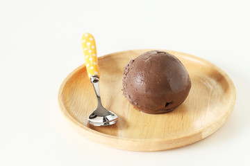 chocolate ice cream in wooden plate on white background