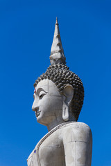 Buddha under construction and blue sky