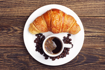 Cup coffee and croissant