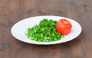 fresh vegetables on the plate. Red tomatoes with green onion